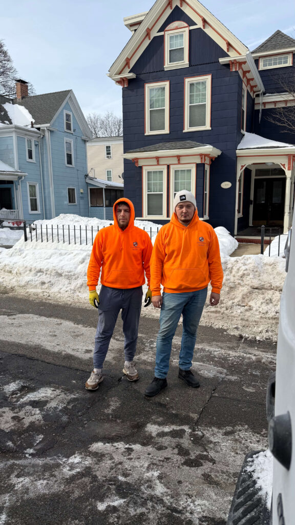 Movers helping with a senior relocation using protective wrapping and organized boxes