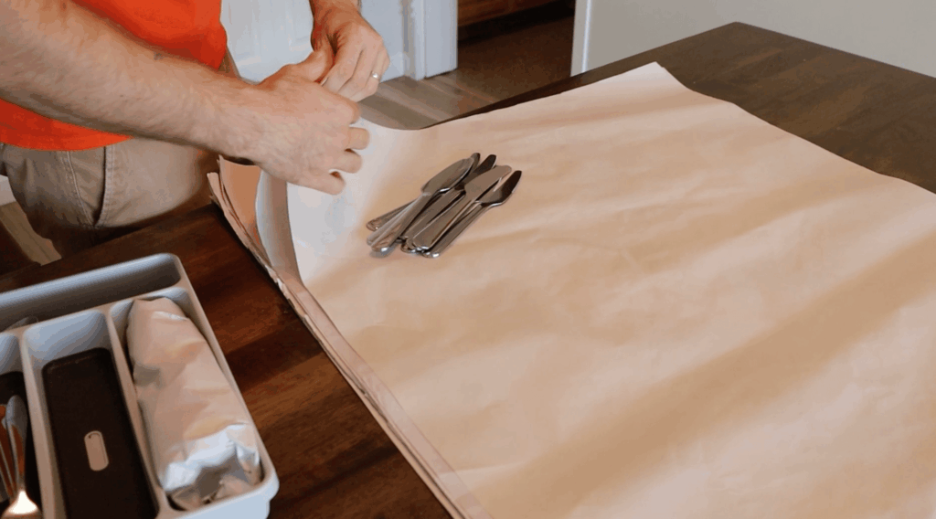 Professional packers wrapping glassware and organizing boxes for easy unpacking