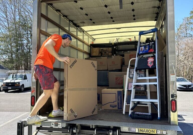 movers loading packages in a van